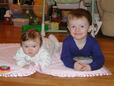 Jakob and Lea sitting on blanket in living room